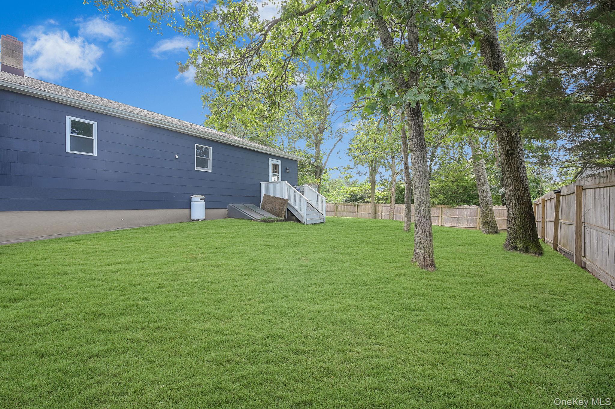 222 Blue Point Road Farmingville, NY 11738 - Photo 31 of 37 a view of a backyard with a small cabin
