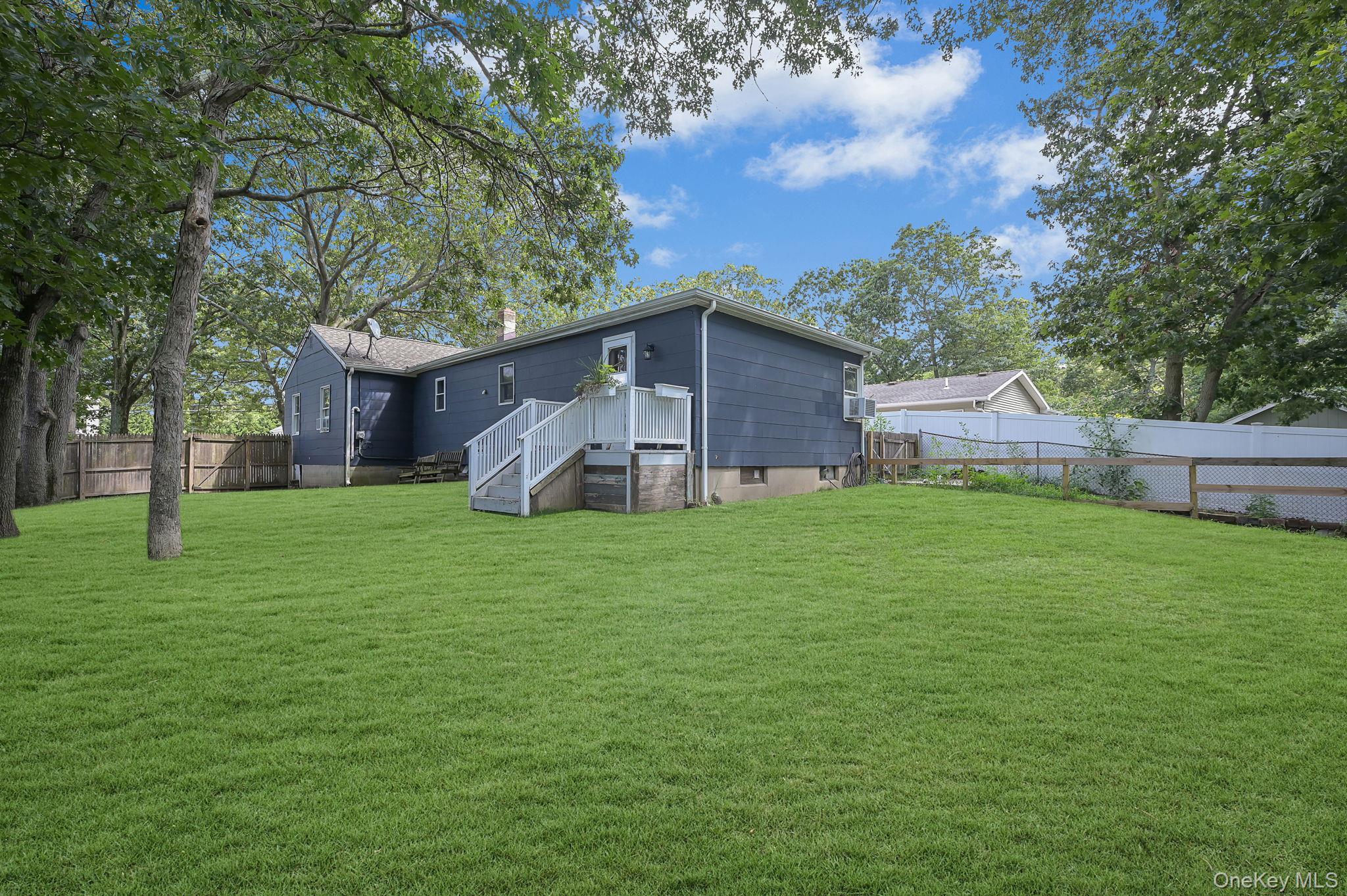 222 Blue Point Road Farmingville, NY 11738 - Photo 33 of 37 a view of a house with a yard