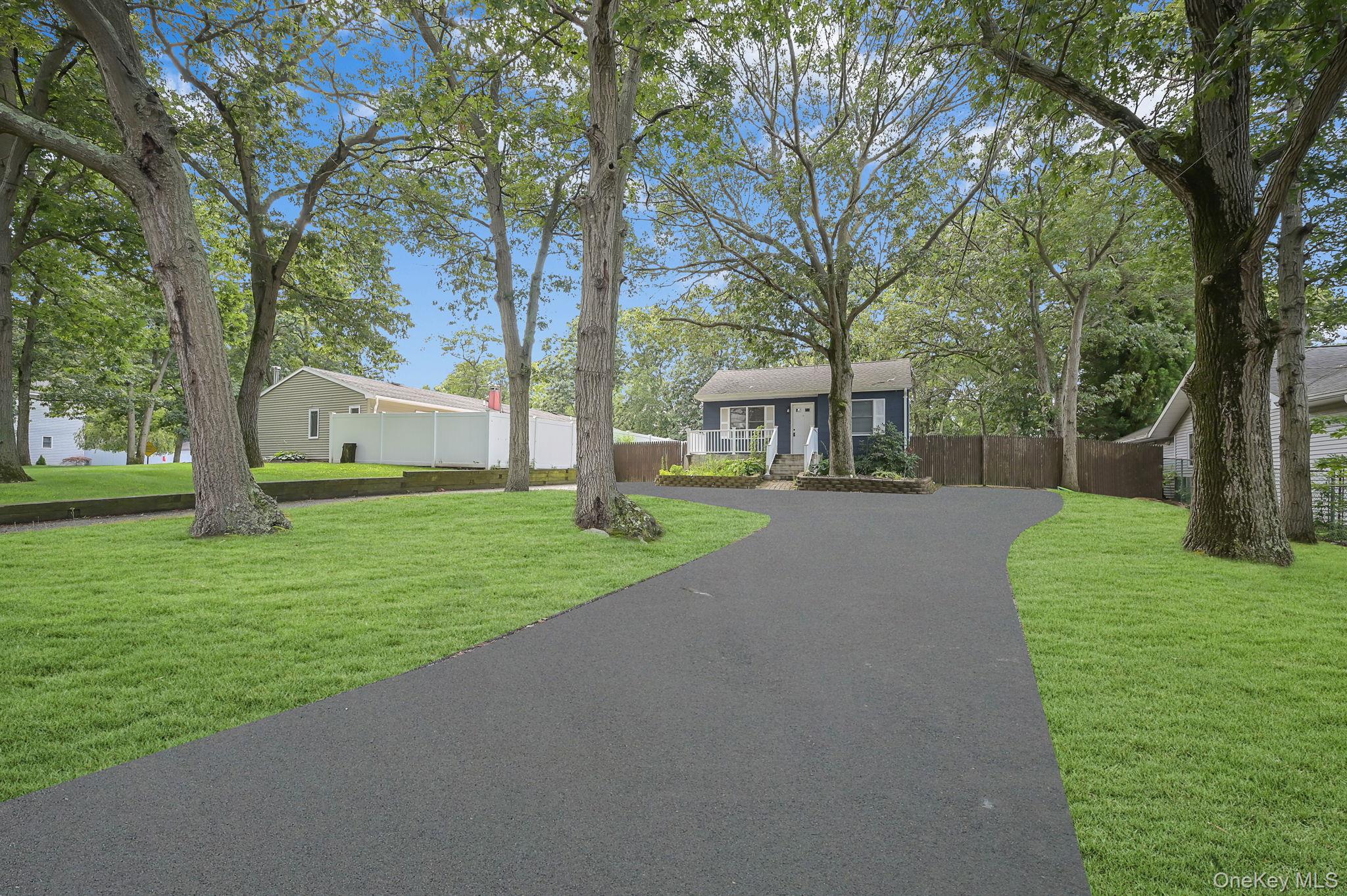 222 Blue Point Road Farmingville, NY 11738 - Photo 34 of 37 a view of a house with a yard