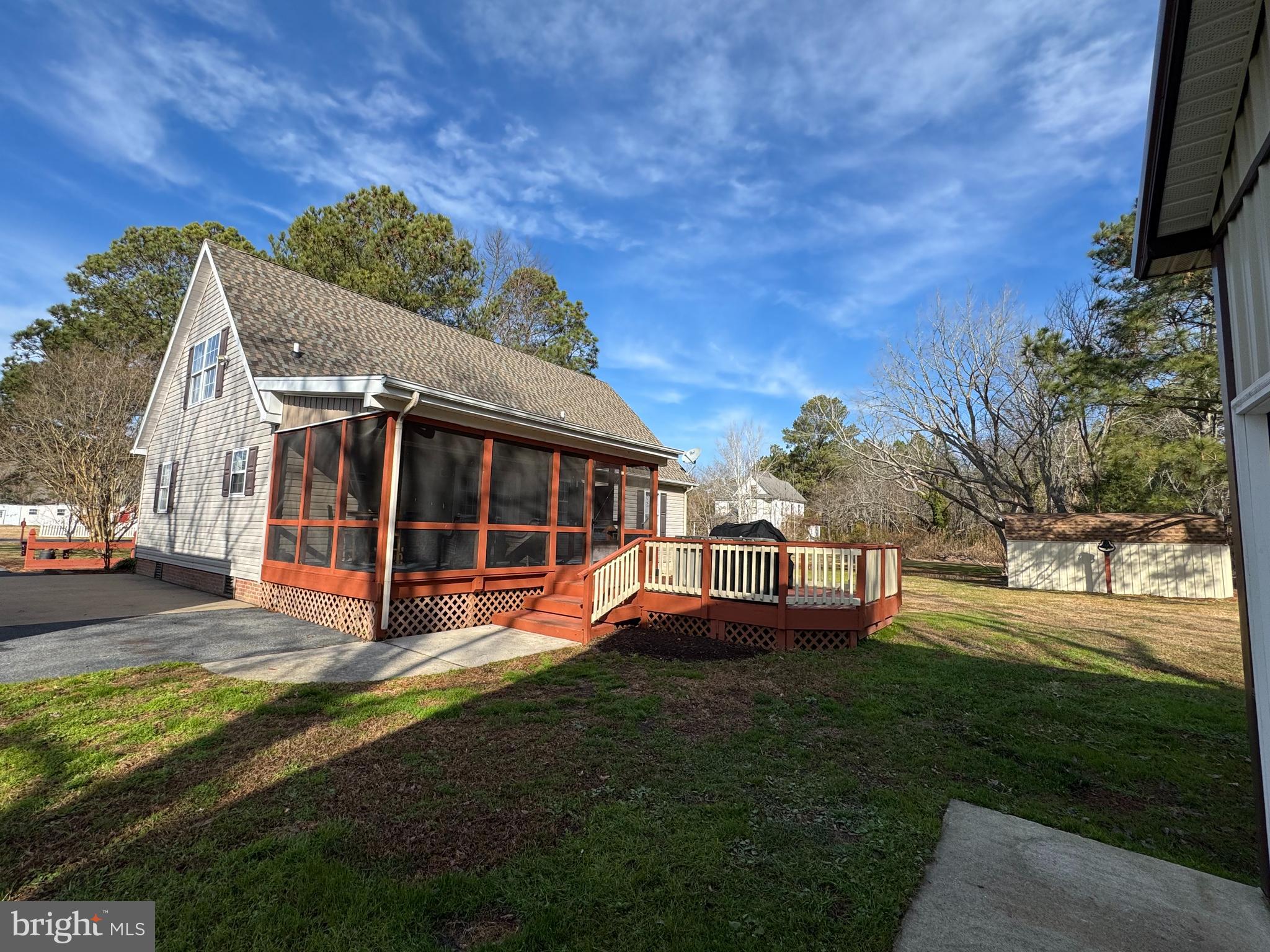 26759 Old State Road Crisfield, MD 21817 - Photo 12 of 17 a view of a house next to a big yard with plants and large trees