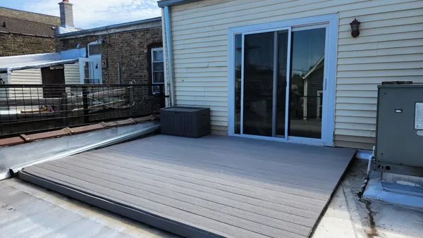 a view of a house with wooden deck