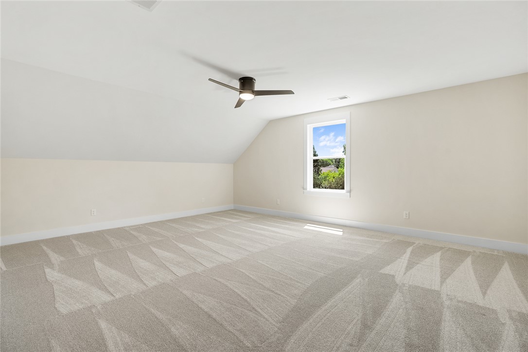 100 Garden Gate Drive Anderson, SC 29621 - Photo 33 of 43 This spacious attic boasts plush carpeting and ample natural light, ideal for a flexible living area.