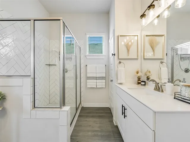 a bathroom with a double vanity sink and mirror
