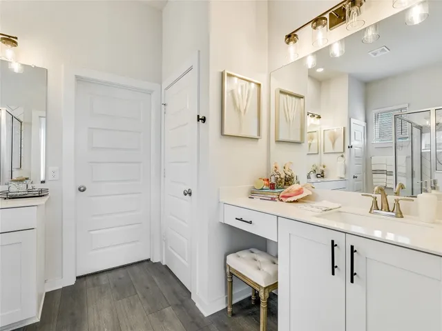 a bathroom with a sink a vanity and a mirror