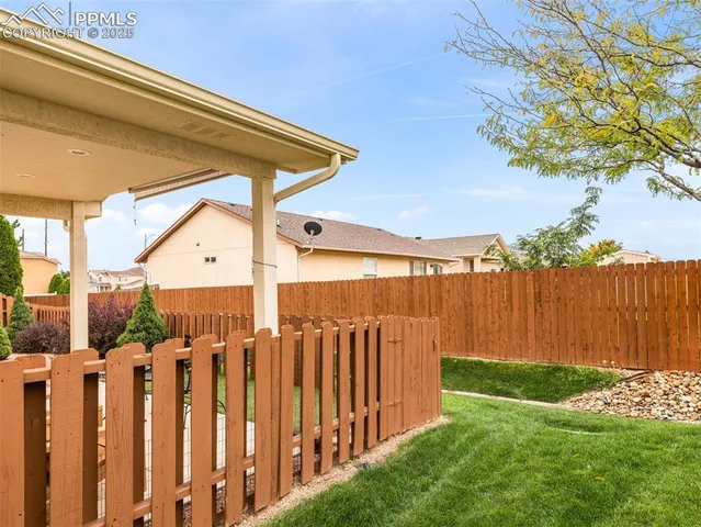 a view of a backyard with wooden fence