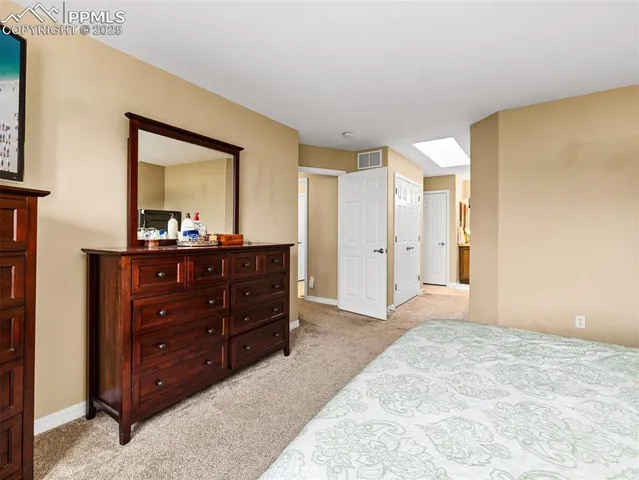 a bedroom with a bed and a dresser in it