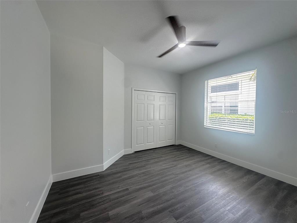 7724 US Open Loop Lakewood Ranch, FL 34202 - Photo 15 of 40 a view of an empty room with wooden floor and a window