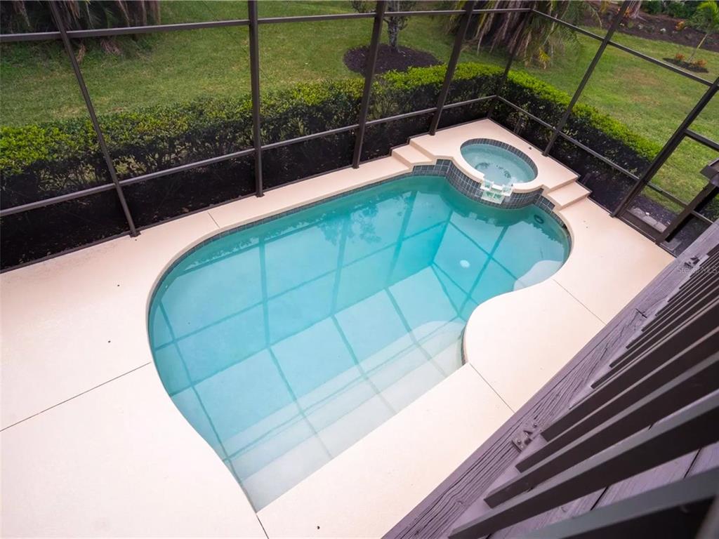 7724 US Open Loop Lakewood Ranch, FL 34202 - Photo 23 of 40 a view of a balcony with floor to ceiling windows and wooden floor