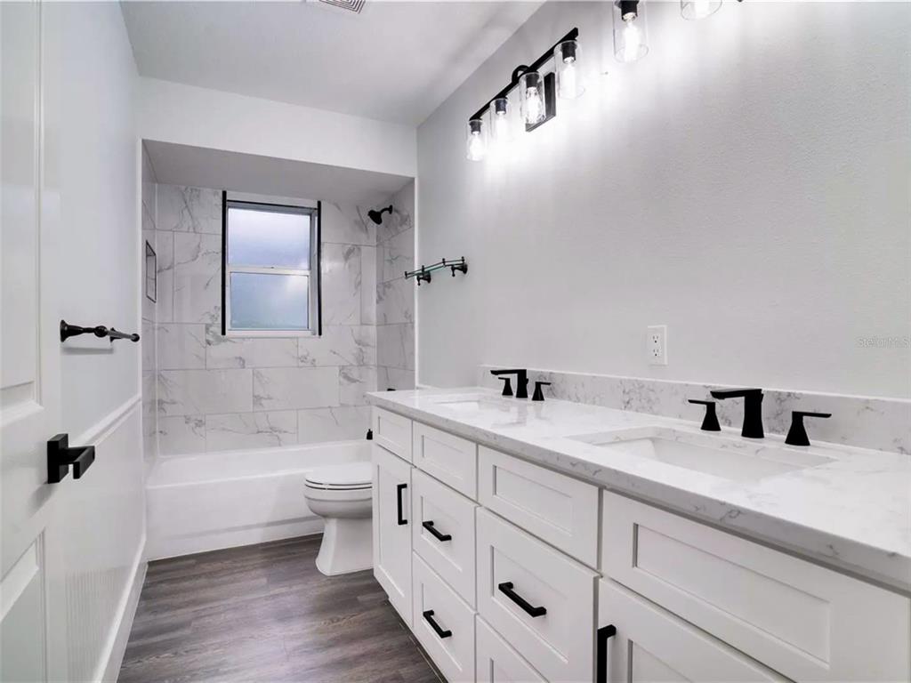 7724 US Open Loop Lakewood Ranch, FL 34202 - Photo 29 of 40 a bathroom with a double vanity sink toilet and shower