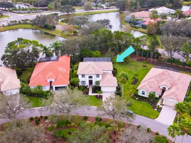 an aerial view of a house with a garden and swimming pool