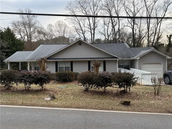 a front view of a house with a yard and a garage