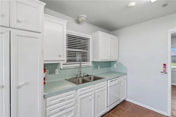a kitchen with granite countertop a sink and a stove