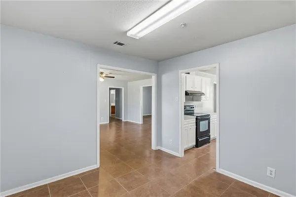 a view of a hallway with wooden cabinet and entryway