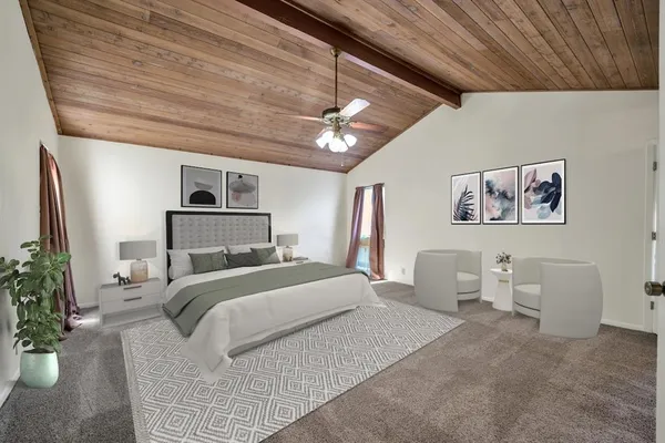 a bedroom with a large bed and a chandelier