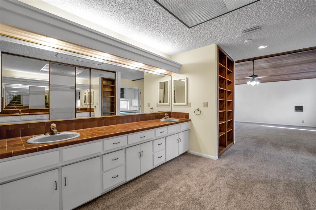 16753 Rolling Hills Lane Forney, TX 75126 - Photo 18 of 32 a spacious bathroom with double vanity and mirrors