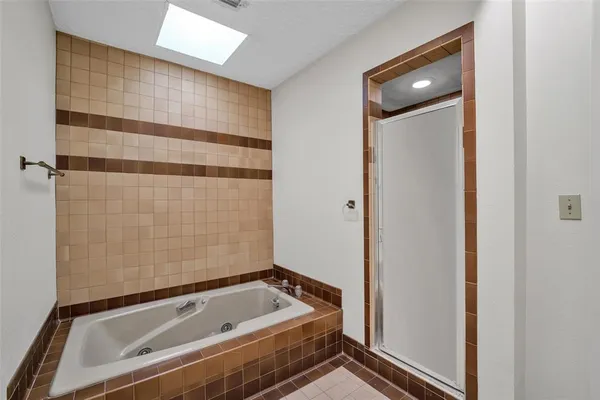 a bathroom with a tub and shower