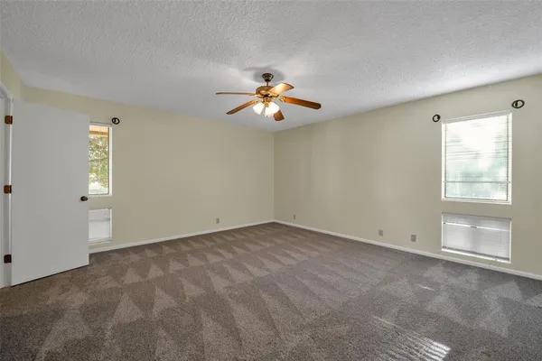 a house view with a ceiling fan and window