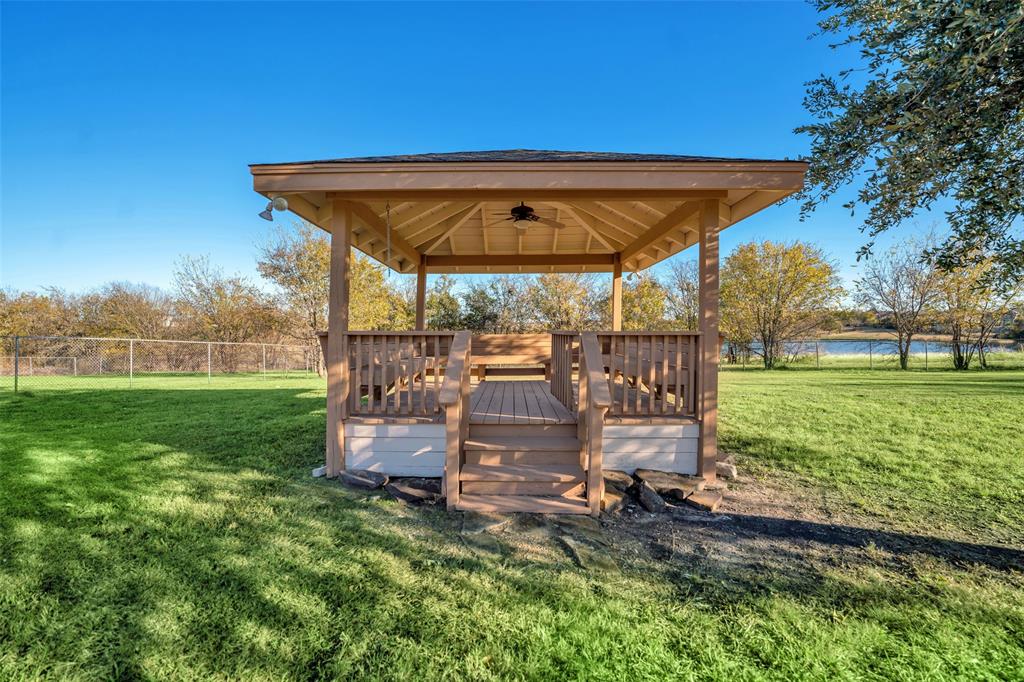 16753 Rolling Hills Lane Forney, TX 75126 - Photo 27 of 32 a view of a back yard with a table and chairs under an umbrella