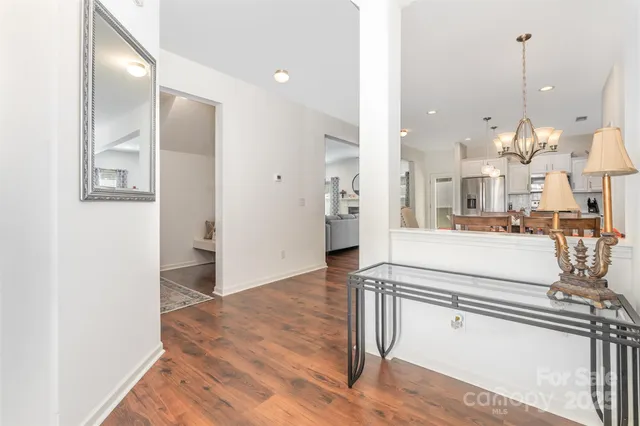 a view of a kitchen with kitchen island and stainless steel appliances