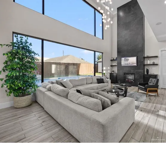 a living room with furniture potted plant and a large window