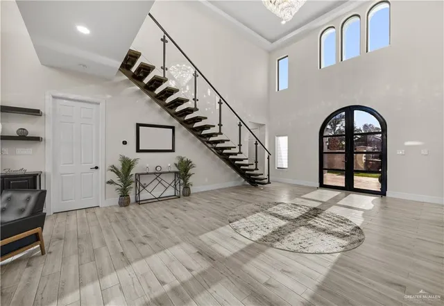 a view of entryway and hall with wooden floor
