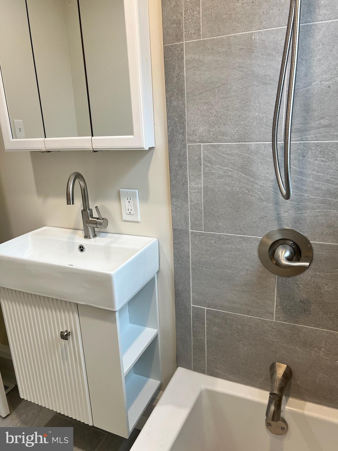 362 Ripka Street Philadelphia, PA 19128 - Photo 12 of 18 a bathroom with a sink a mirror and shower