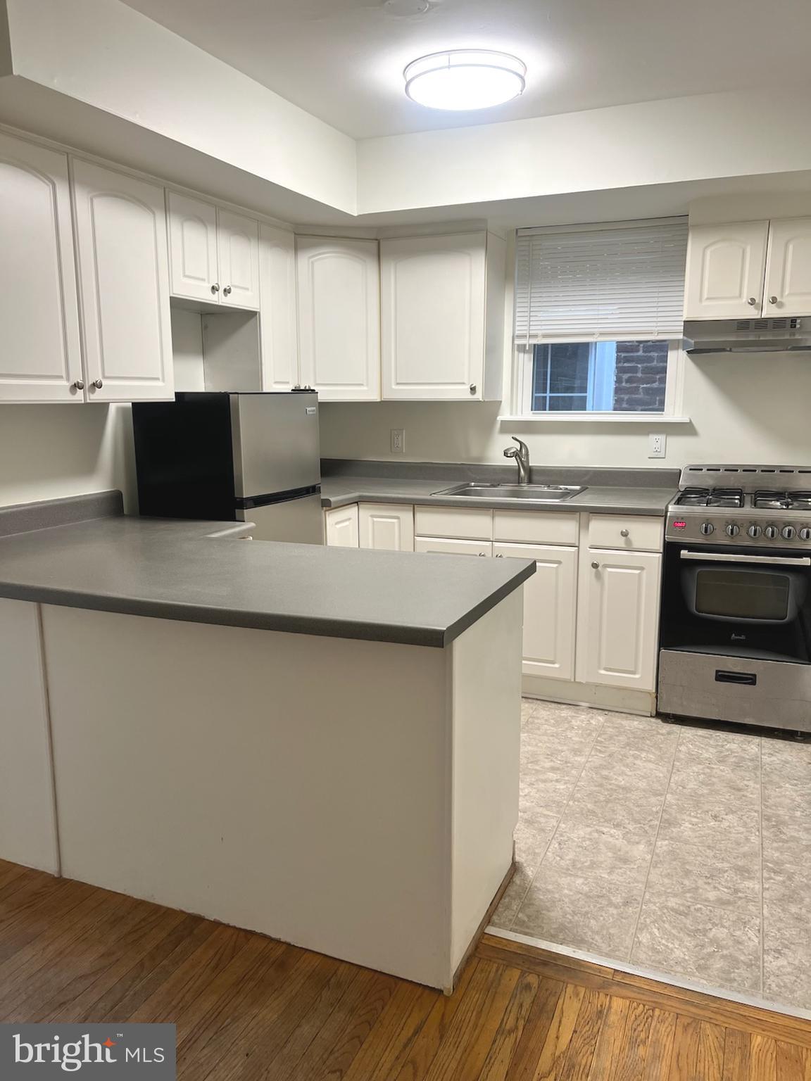 362 Ripka Street Philadelphia, PA 19128 - Photo 4 of 18 a kitchen with stainless steel appliances granite countertop a stove a sink and a microwave