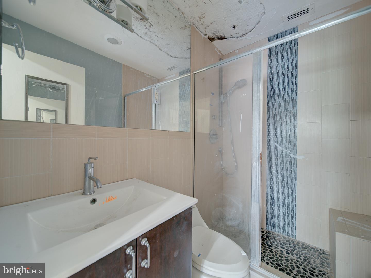 2829 Connecticut Avenue Northwest, Unit 606 Washington, DC 20008 - Photo 19 of 28 a bathroom with a sink a toilet and shower