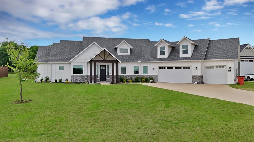 2223 Providence Way Nevada, TX 75173 - Photo 2 of 40 a front view of a house with a garden and yard