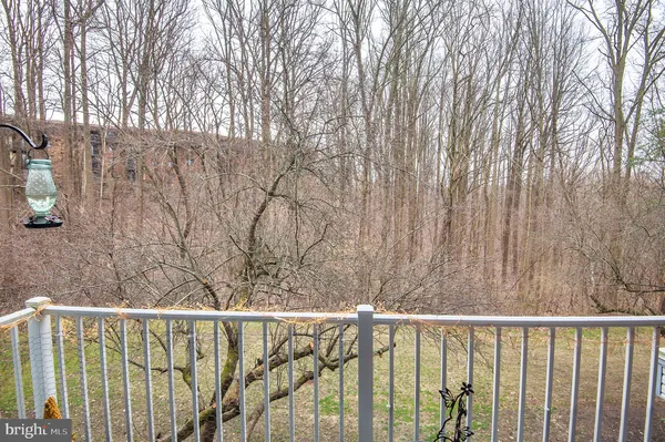 a view of balcony with wooden floor and fence