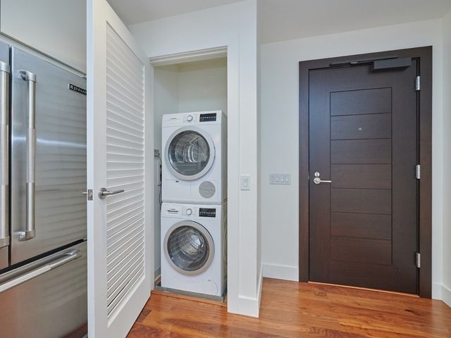a view of a hallway with washer and dryer