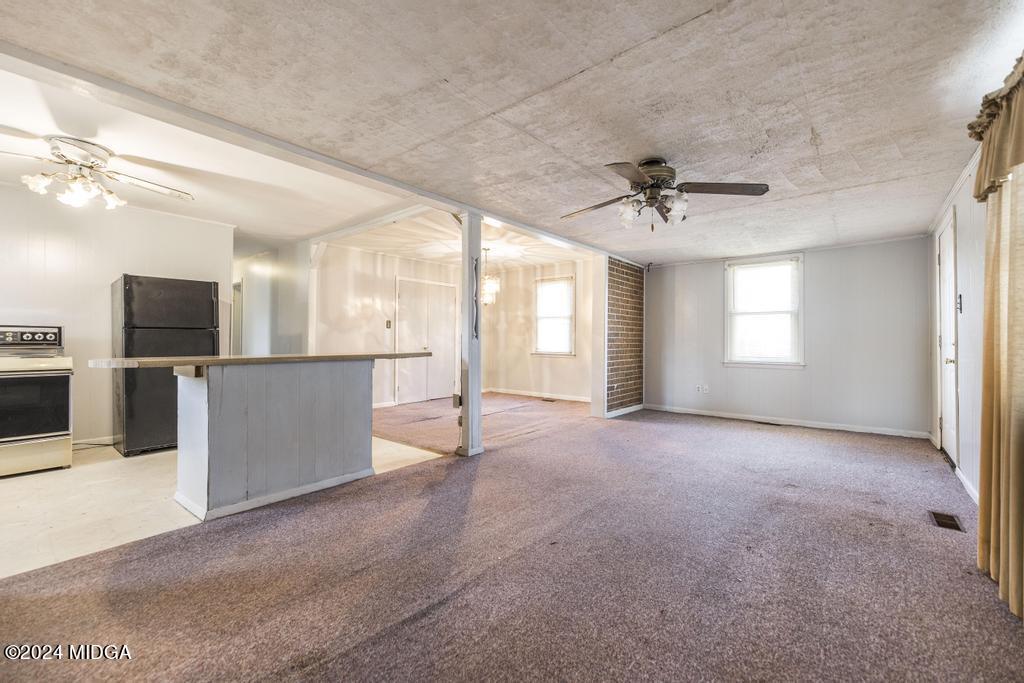 4632 Brookhaven Road Macon, GA 31206 - Photo 6 of 20 a view of a big room with windows and a kitchen