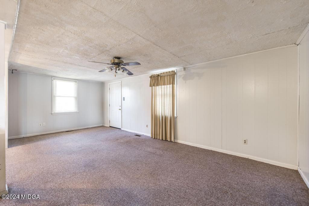 4632 Brookhaven Road Macon, GA 31206 - Photo 7 of 20 a view of a big room with windows and chandelier fan