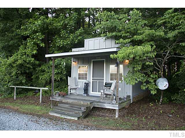 803 Fieldstone Road Roxboro, NC 27574 - Photo 11 of 25 a view of house with backyard outdoor seating and green space
