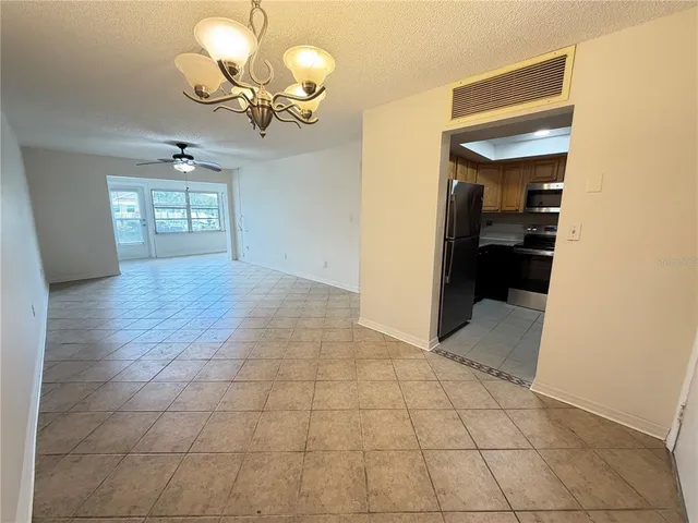 a view of hallway with livingroom and stairs