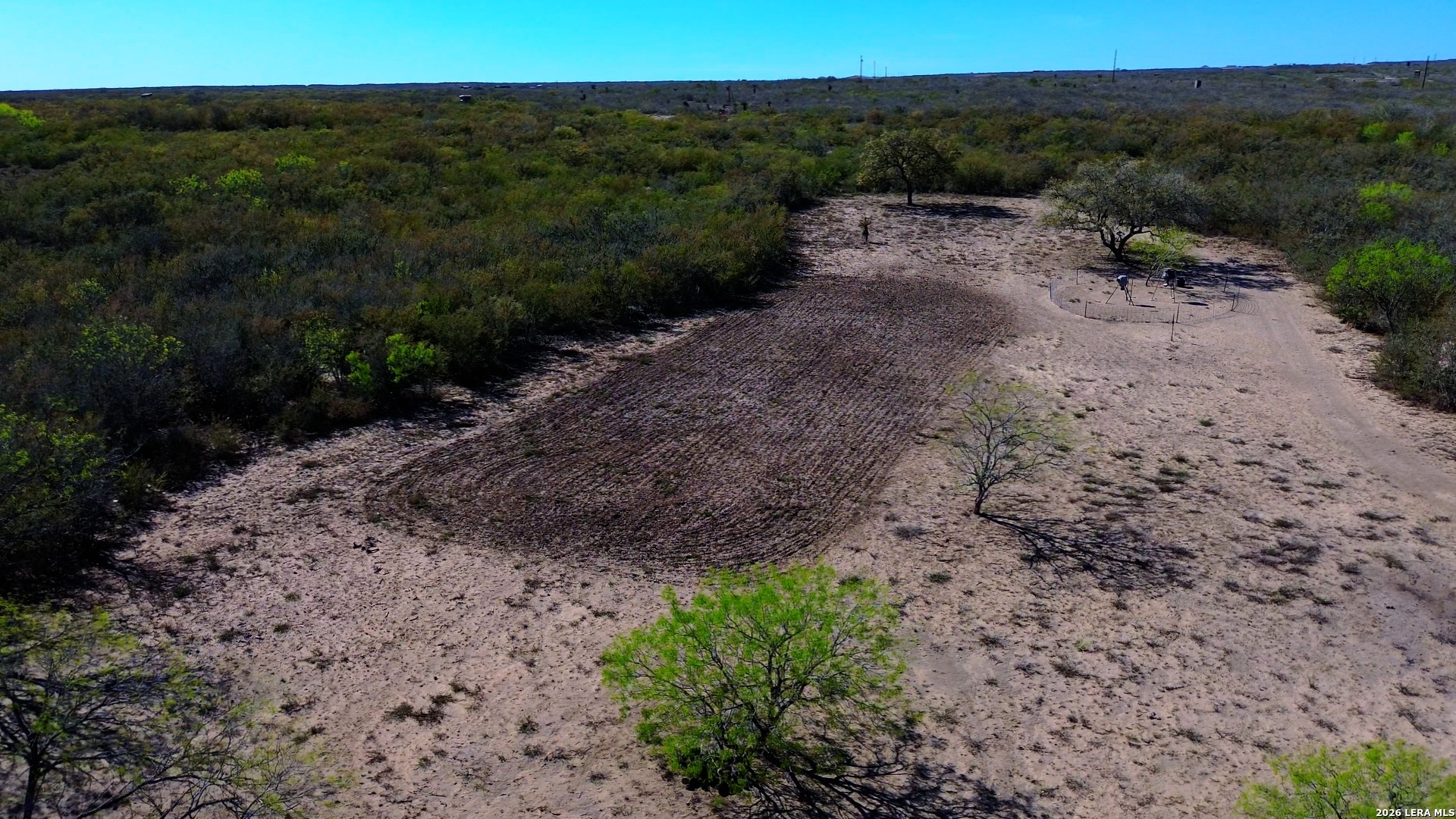 128 Salyer George George West, TX 78022 - Photo 15 of 18 a view of a dry yard with trees