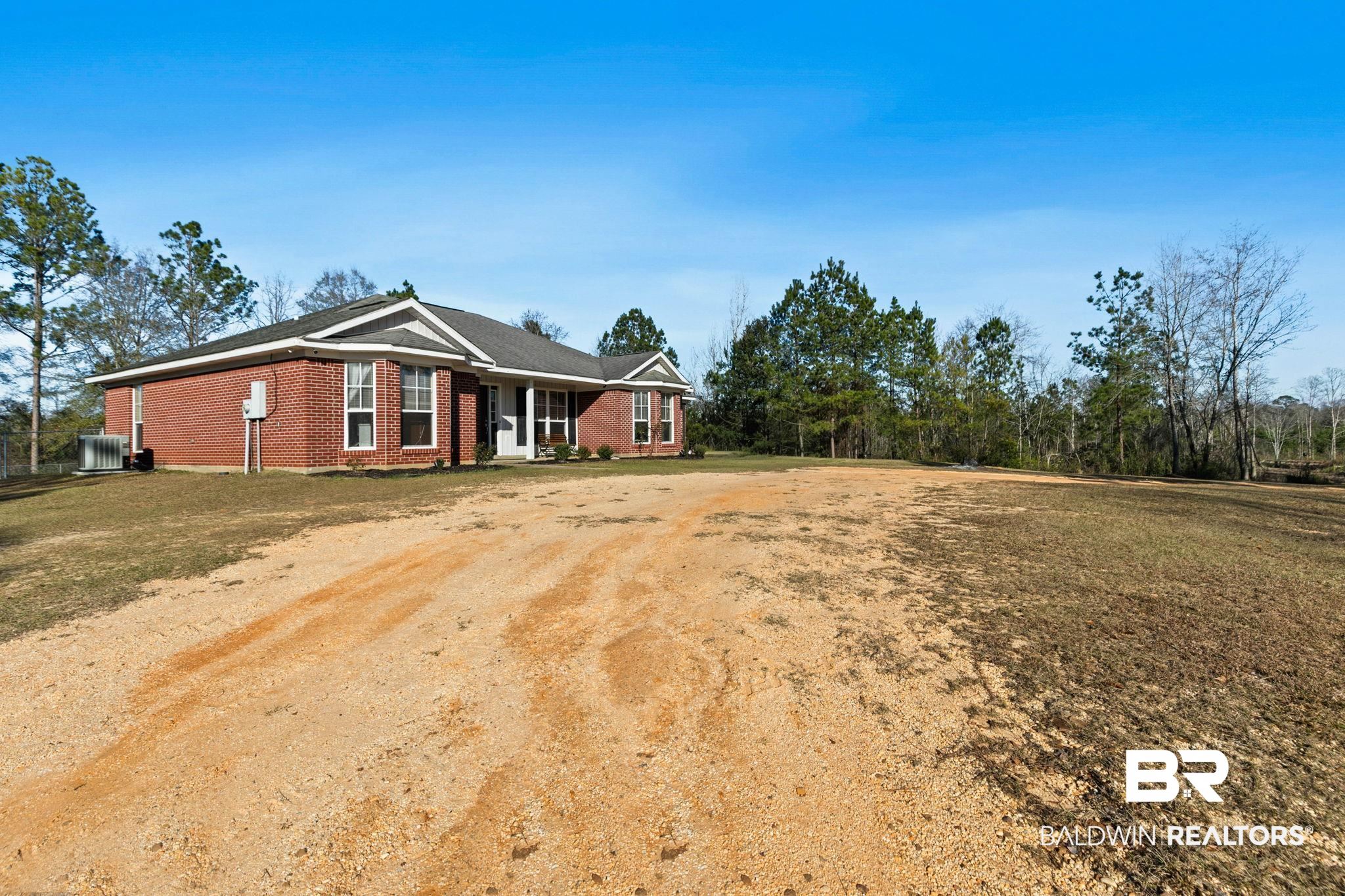 55750 Lottie Road Perdido, AL 36562 - Photo 81 of 84 View of front of house with brick siding, driveway, and a front lawn