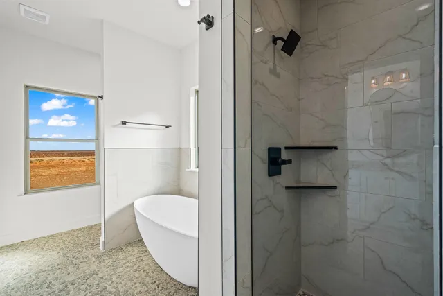 a bathroom with a granite countertop shower a sink and a toilet