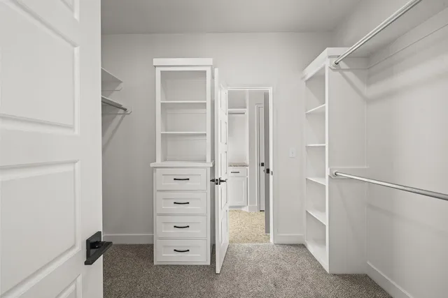 a view of walk in closet with empty racks