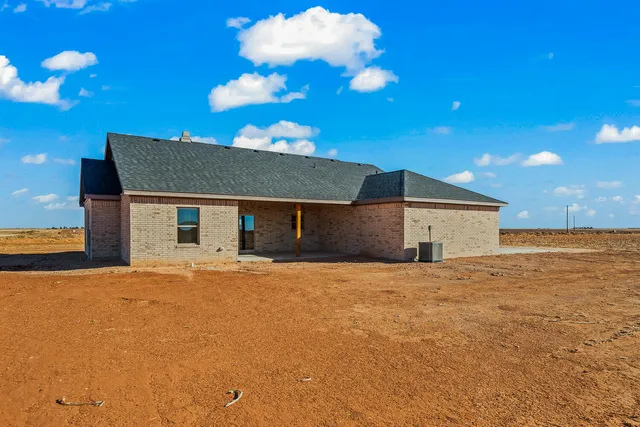 a front view of house with yard and ocean view