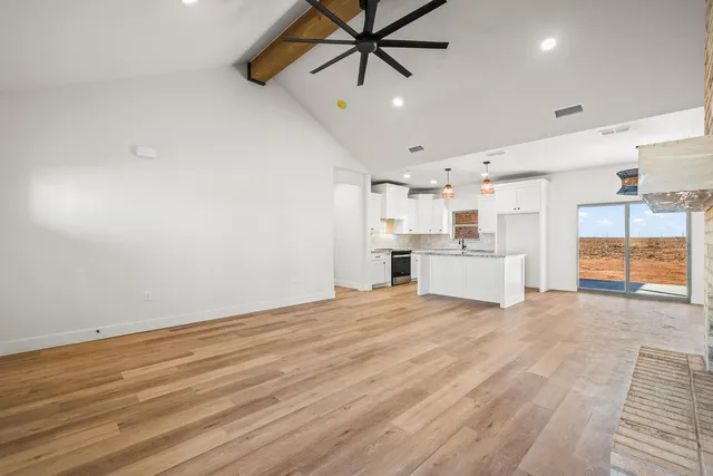 a view of a livingroom with a ceiling fan and window