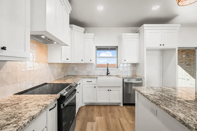 a kitchen with a sink stove and cabinets