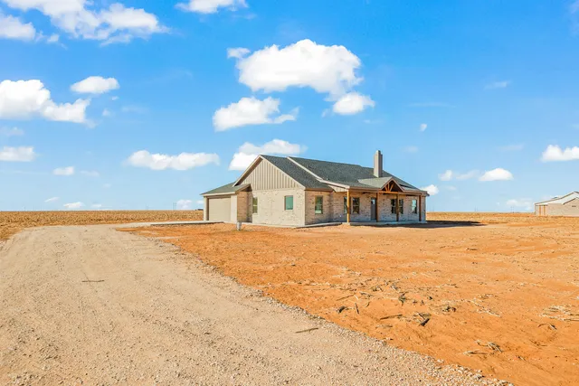 a view of house with yard and ocean view