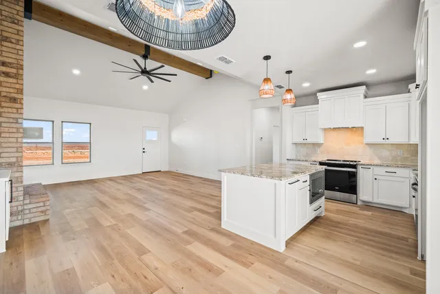a kitchen with a stove a sink and a refrigerator