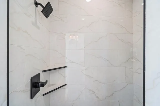 a bathroom with a shower and a window