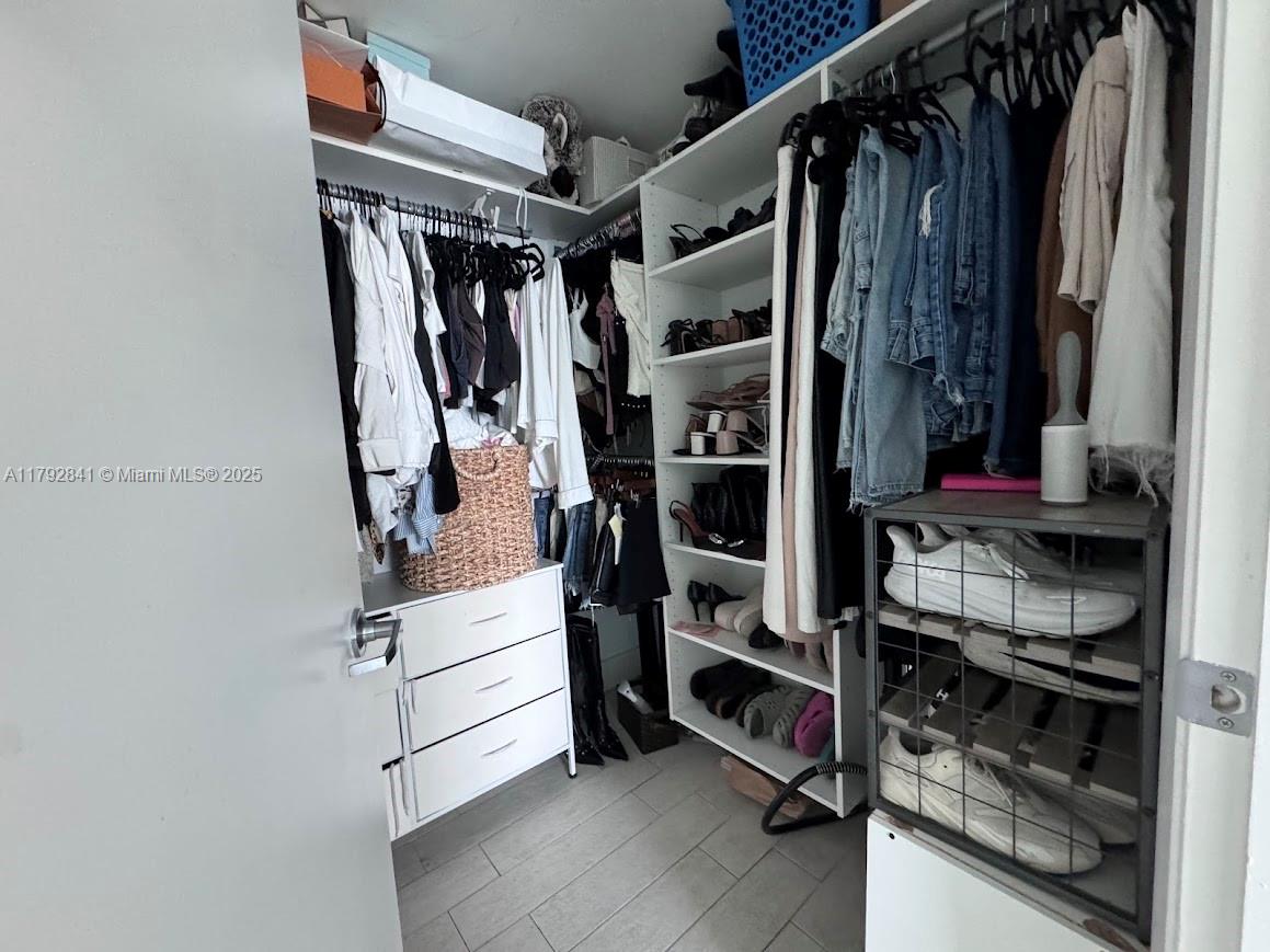 92 Southwest 3rd Street, Unit 3903 Miami, FL 33130 - Photo 11 of 25 a view of walk in closet with clothes and shoes