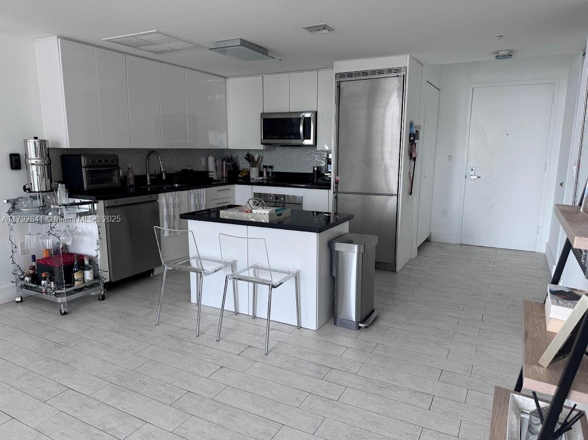 92 Southwest 3rd Street, Unit 3903 Miami, FL 33130 - Photo 4 of 25 a kitchen with a sink cabinets and appliances