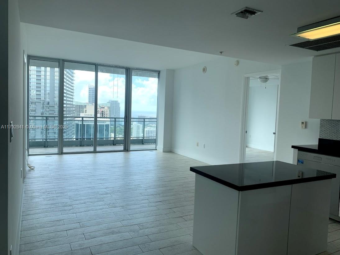 92 Southwest 3rd Street, Unit 3903 Miami, FL 33130 - Photo 5 of 25 a kitchen with stainless steel appliances granite countertop a sink a stove and a large window