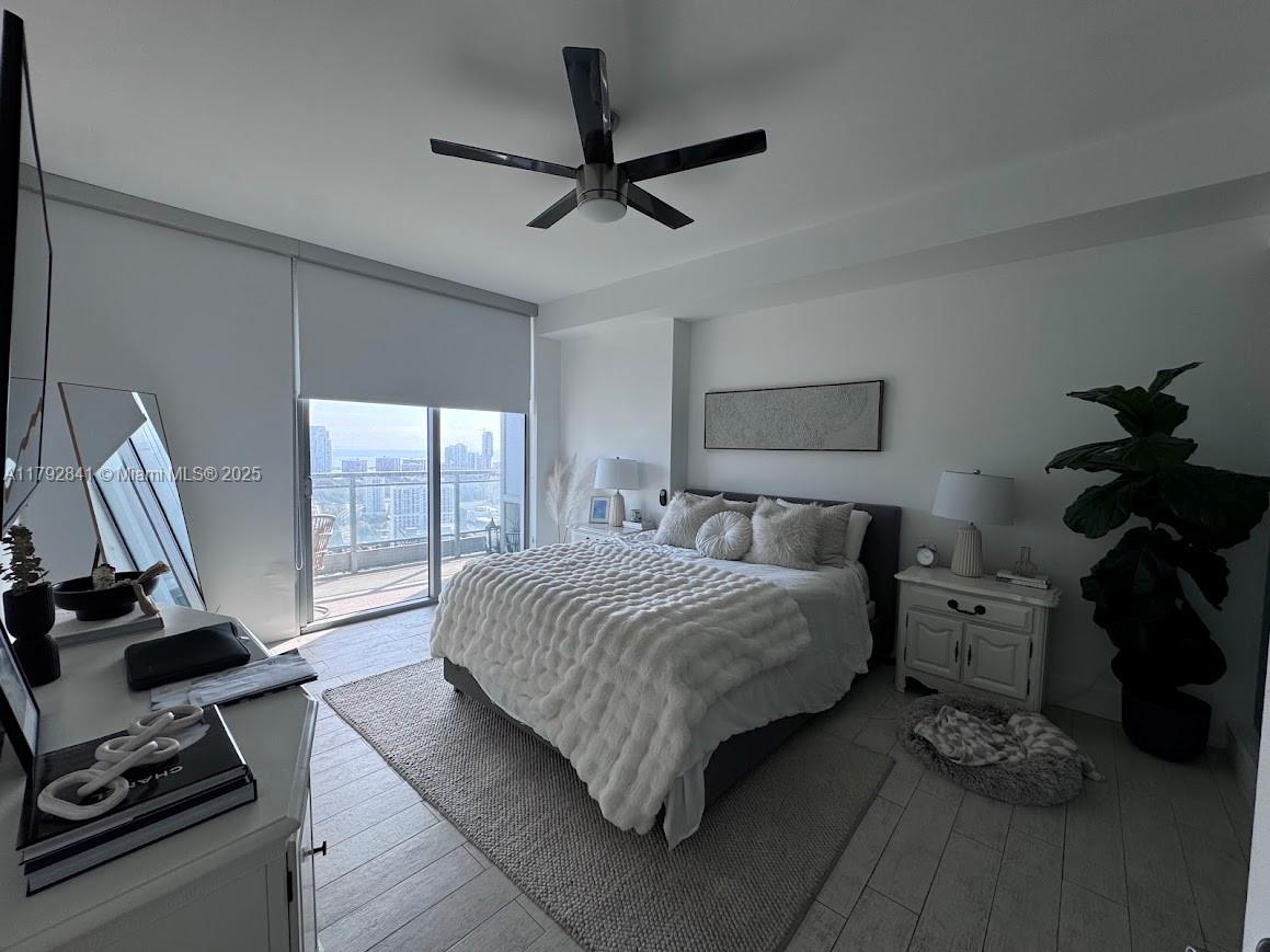 92 Southwest 3rd Street, Unit 3903 Miami, FL 33130 - Photo 6 of 25 a bedroom with a bed furniture and a window