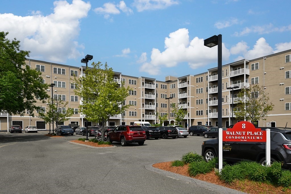 8 Walnut Street, Unit 406 Peabody, MA 01960 - Photo 1 of 31 a city street lined with parked cars and buildings
